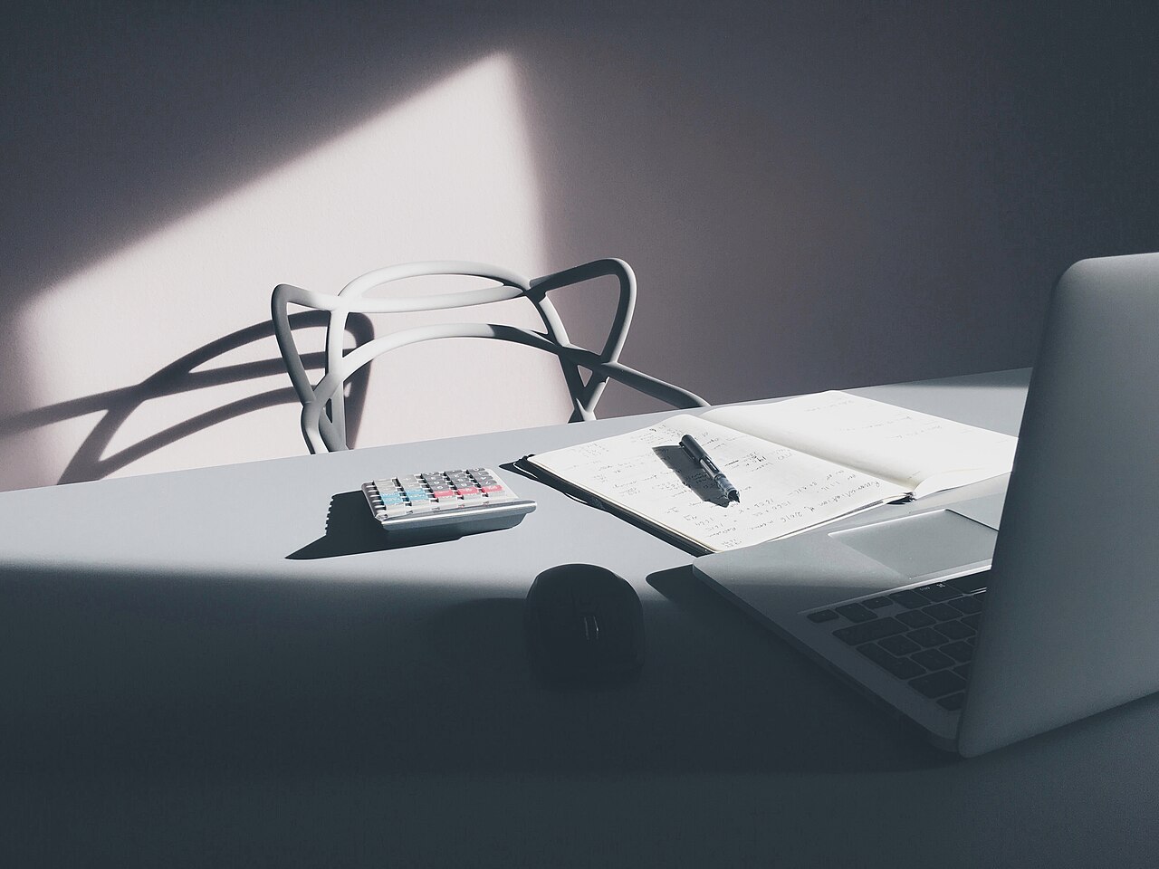 Desktop with a laptop and calculator used for reserve and tax calculations
