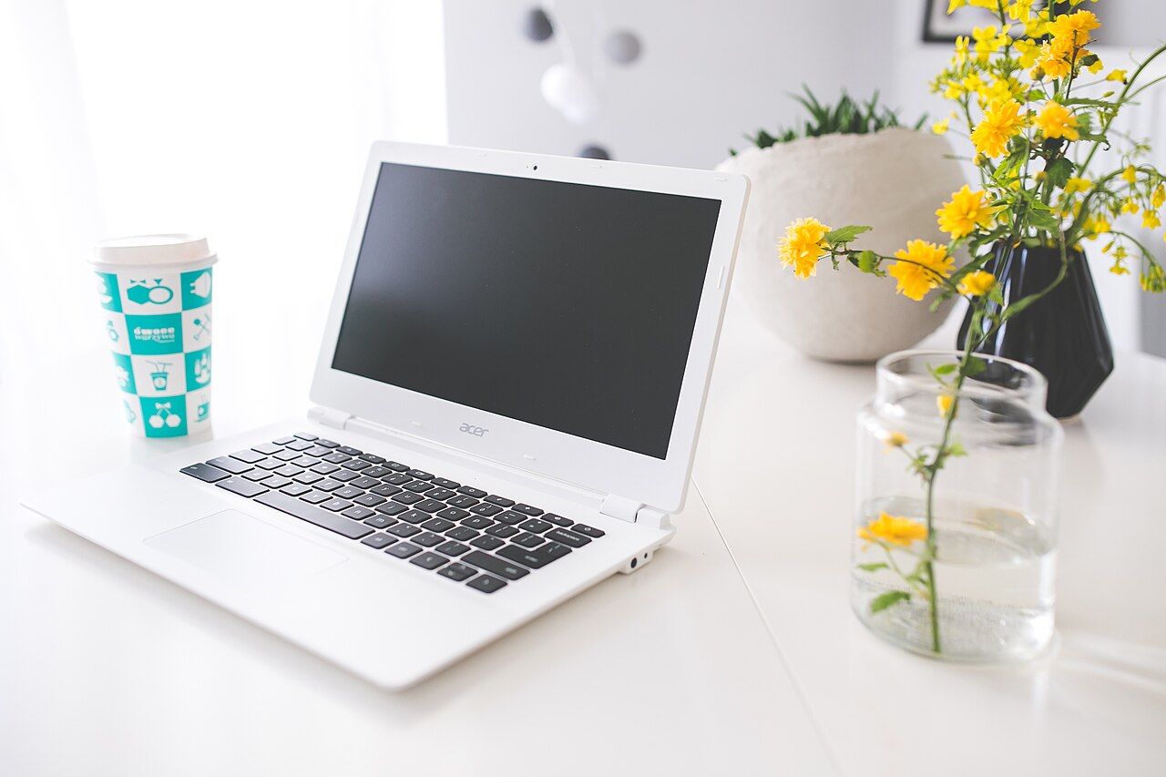 Open notebook and laptop used to map out monthly cash flow